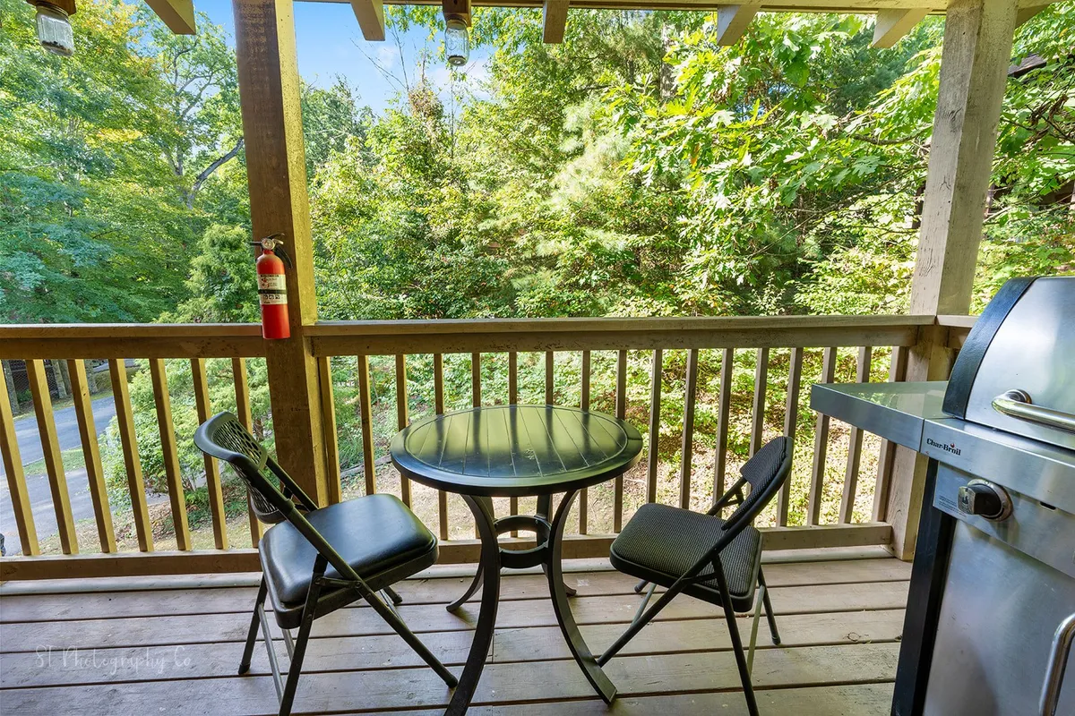 An outdoor dining area set amidst greenery, complete with a table, chairs, and a grill. This tranquil space is ideal for family barbecues and starlit dinners, capturing the fun of outdoor living mentioned in the section.