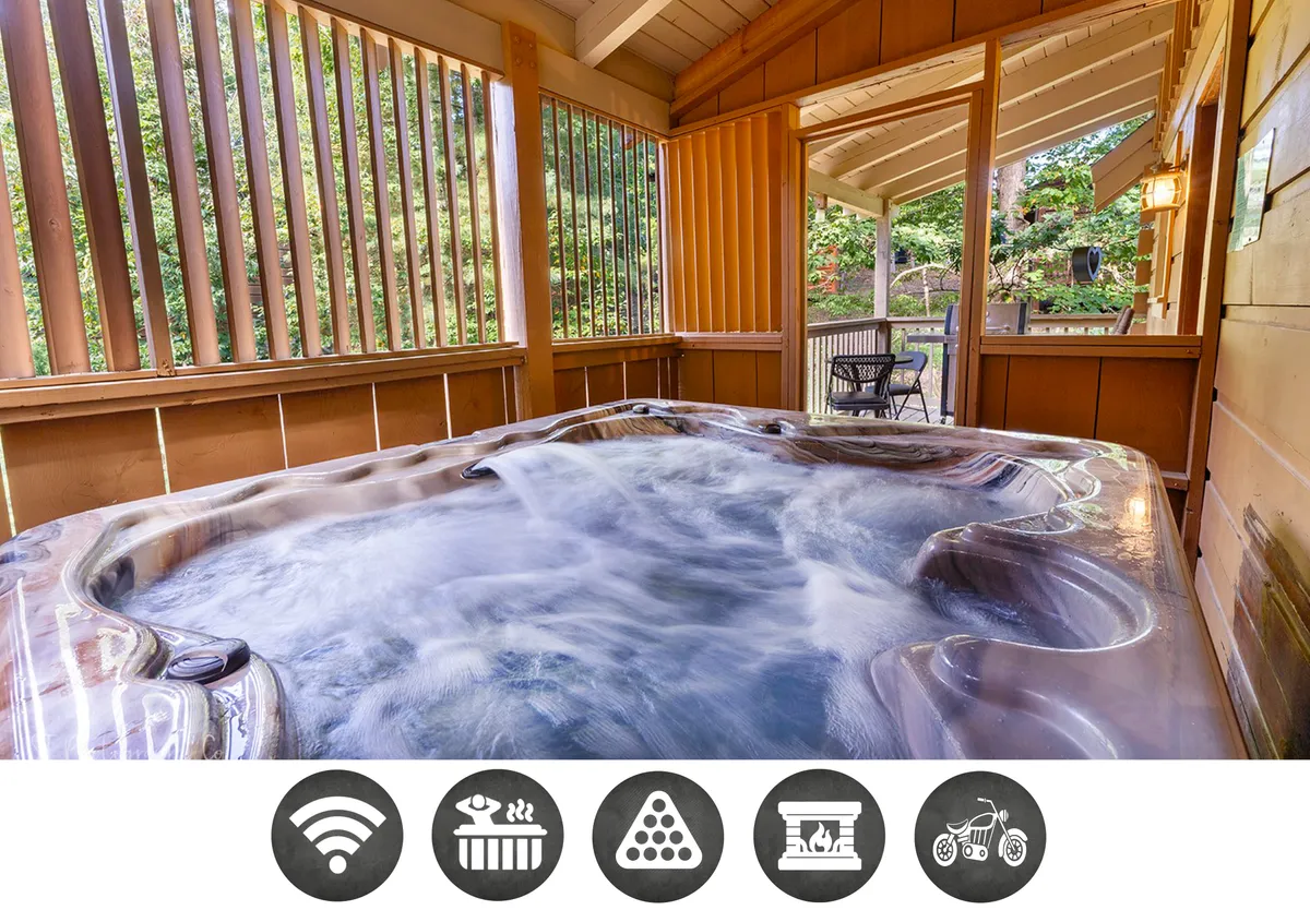 The hero image showcases a cozy, wood-paneled interior centered around a bubbling hot tub with open views to the lush outdoors. The inviting space is bathed in natural light, seamlessly blending indoor comfort with the beauty of the Smoky Mountains, and offers an ideal spot for relaxing, socializing, or enjoying a peaceful morning coffee.